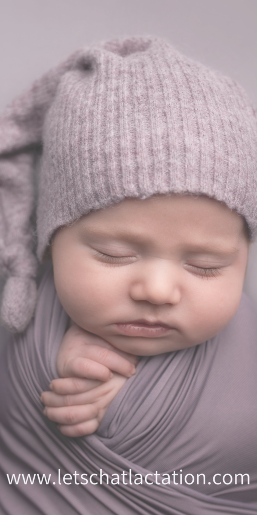 Baby swaddled in a purple blanket sleeping